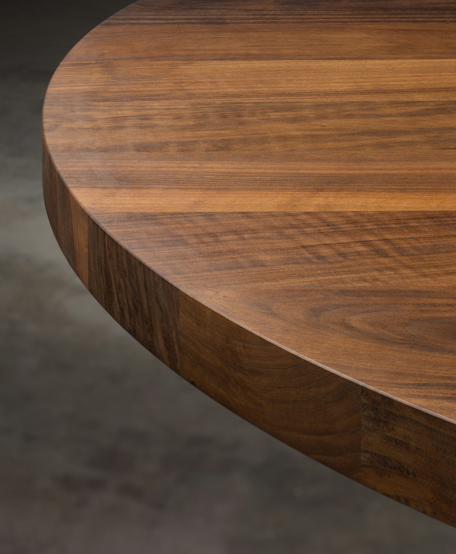 close up of oval ashida table in oiled walnut by e15 furniture