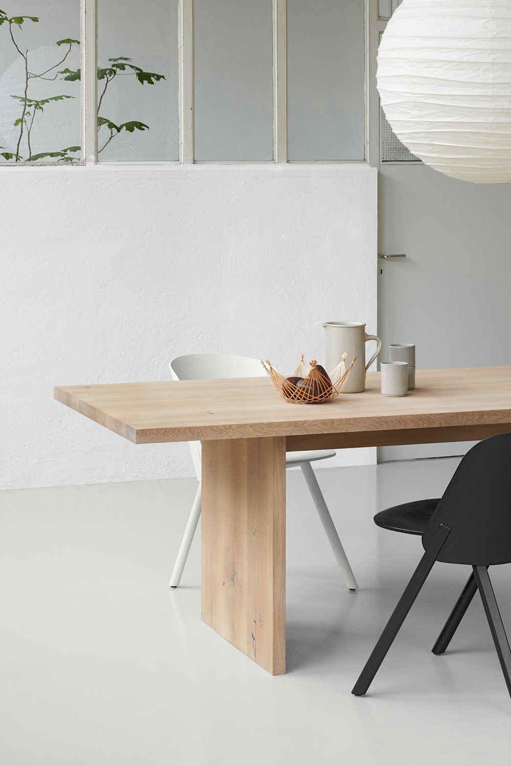 close up of ashida table in white waxed oak with houdini chair by e15 furniture